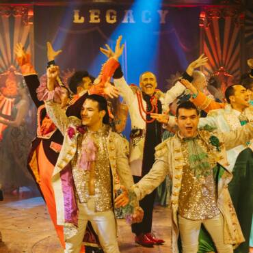 Apertura de espectáculo del Circo Raluy Legacy con artistas del circo eufóricos vestidos con trajes elegantes de presentadores de circo.